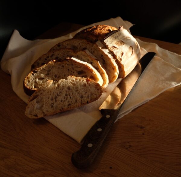 Golden Sunlight Shining on Sourdough Sliced with Breadknife