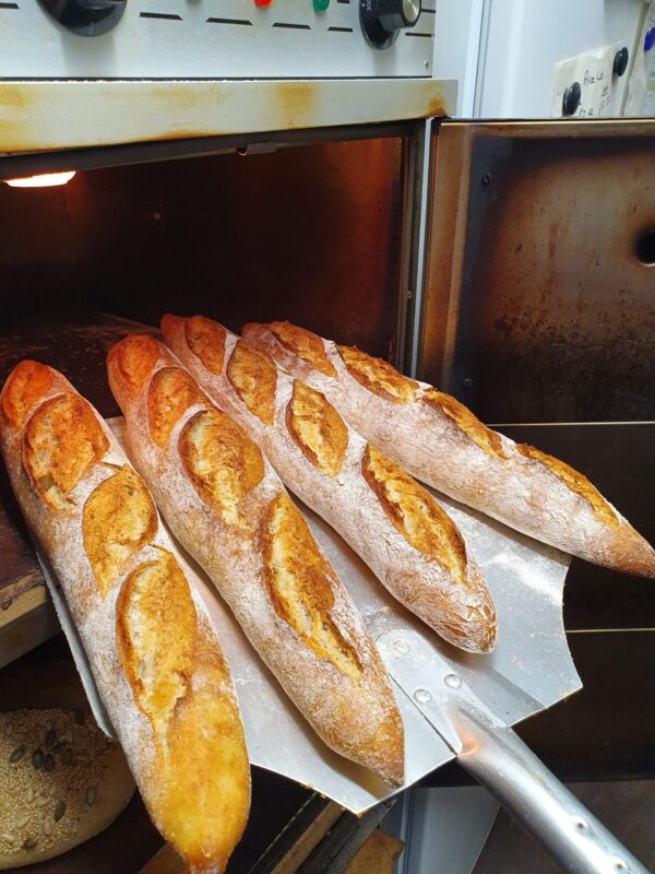 Sourdough Baguettes coming out of oven